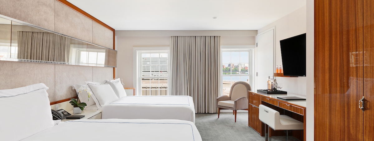 large bedroom with two queen beds and a tv and desk area