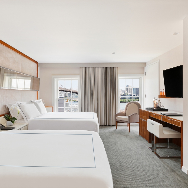 large room with two queen beds and natural light