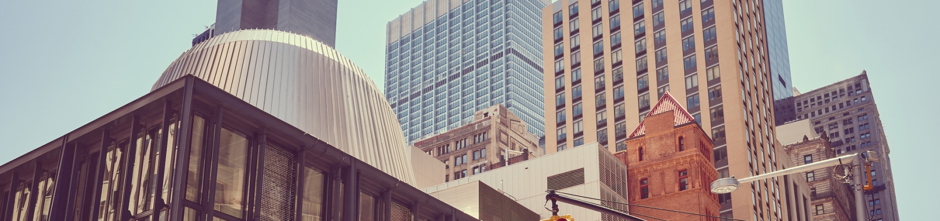 Broadway and Fulton street, color toned picture of New York diverse architecture, USA.