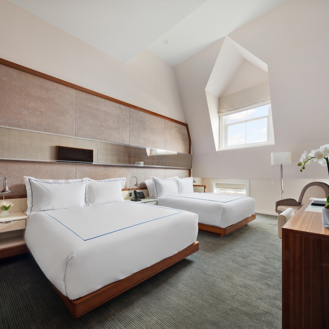 large room with two queen beds and vaulted ceilings