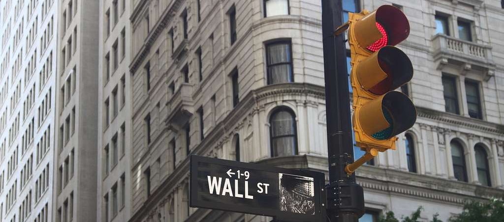 wall street and broadway sign in front of a building